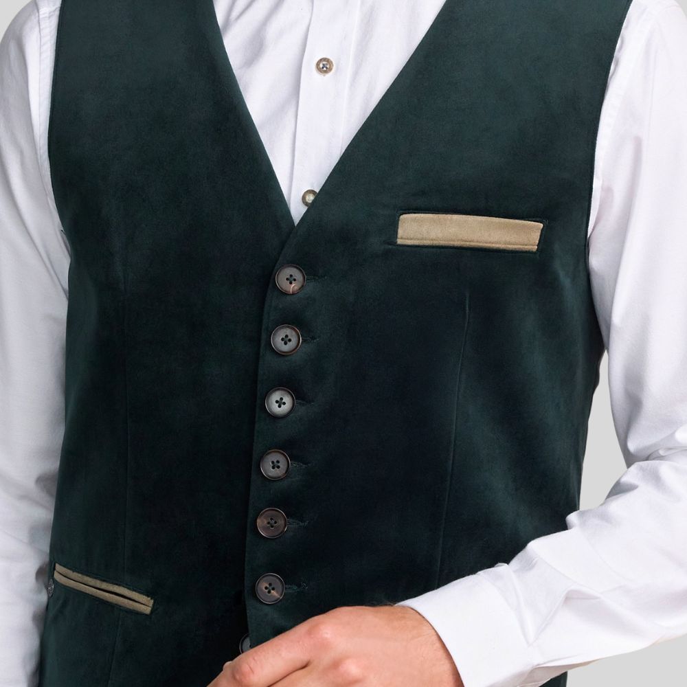 Dark green vest with buttons and a pocket square worn over a white shirt.