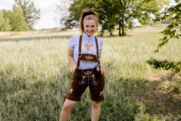 Woman wearing lederhose damen styled with traditional accessories for Oktoberfest.