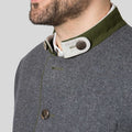 Gray coat with green collar and buttons on a plain background