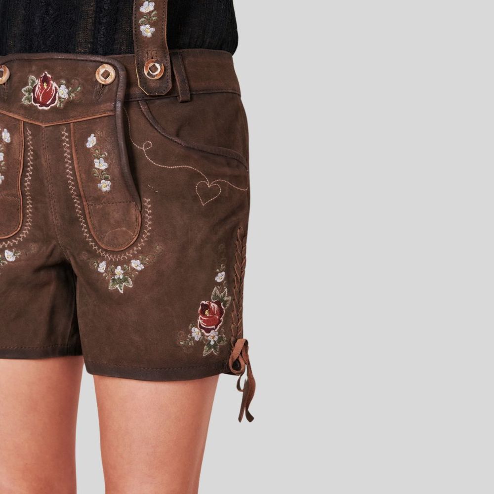 "Traditional Alpine women’s lederhosen in dark brown leather, highlighting detailed stitching and a classic design that embodies authentic mountain style."