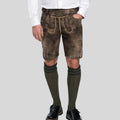 Person wearing traditional Bavarian lederhosen with a white shirt on a light gray background