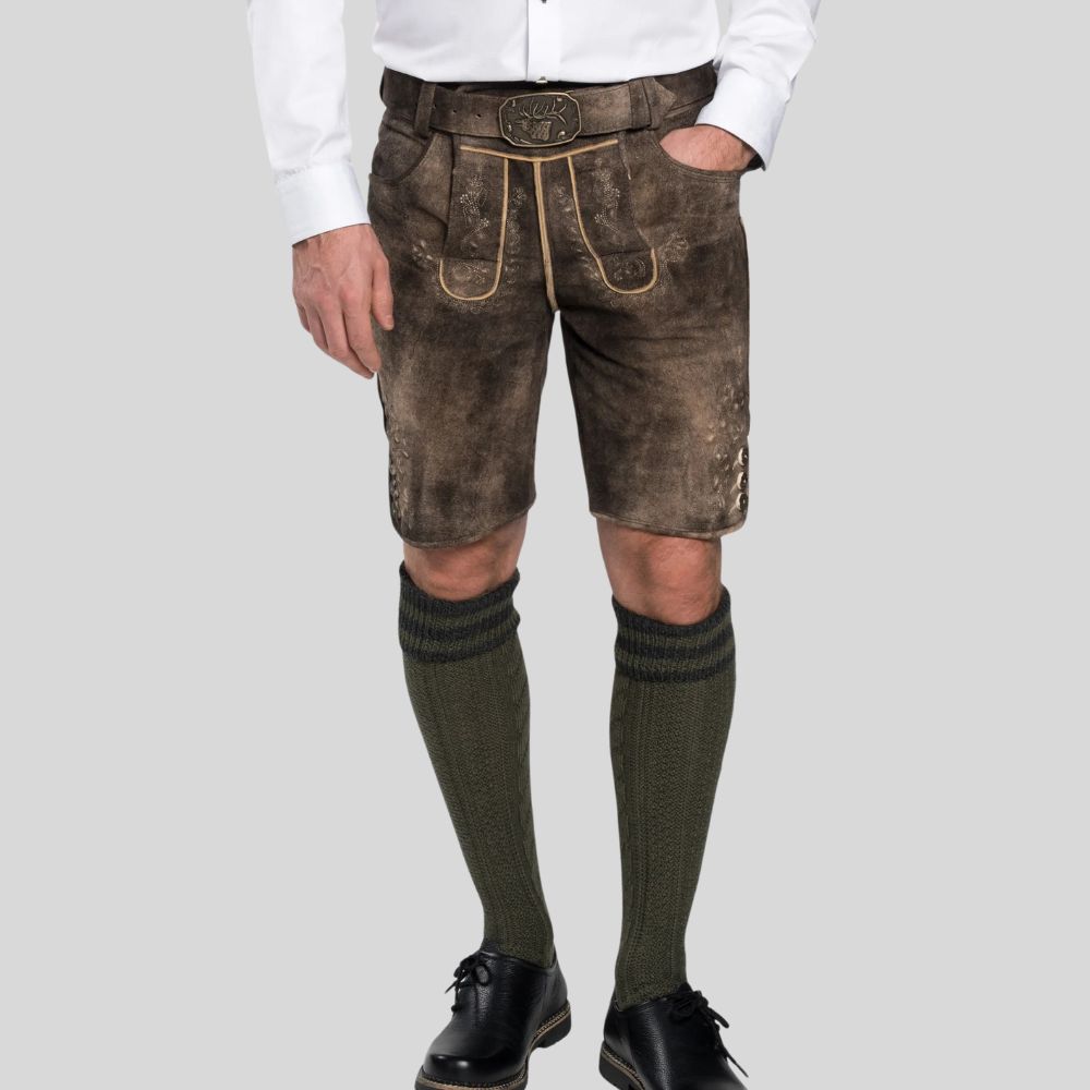 Person wearing traditional Bavarian lederhosen with a white shirt on a light gray background