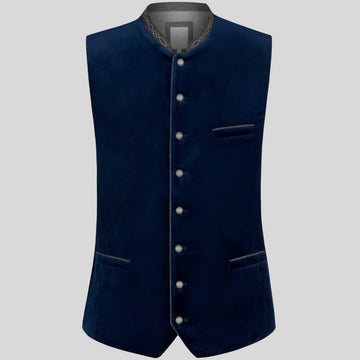 A dark navy blue velvet waistcoat with a mandarin collar, decorative silver-tone buttons down the front, and welt pockets, shown against a solid gray background.